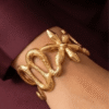 Serpentine — Gold Coiled Snake Cuff Bracelet worn on wrist