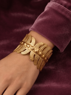 Vela — Gold Ribbed Cuff Bracelet worn on wrist Vela — Gold Ribbed Cuff Bracelet worn on wrist