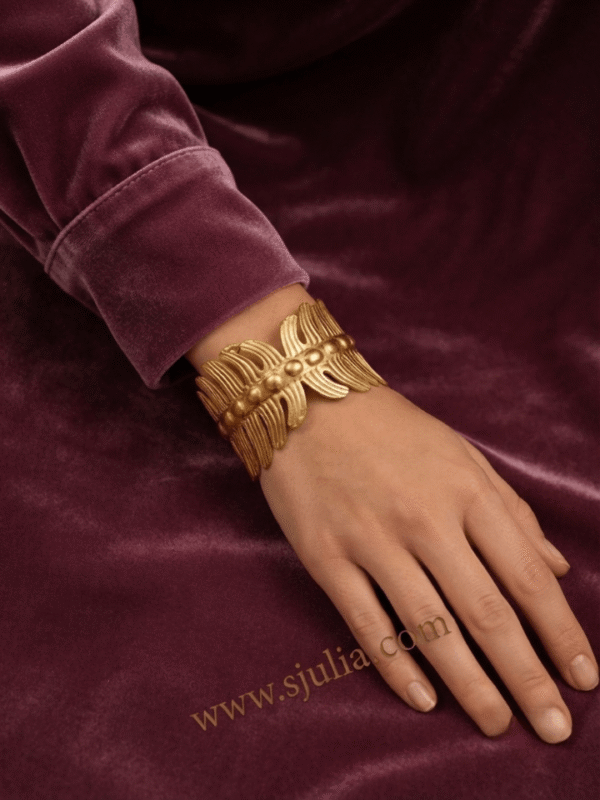 Vela — Gold Ribbed Cuff Bracelet worn on wrist Vela — Gold Ribbed Cuff Bracelet worn on wrist