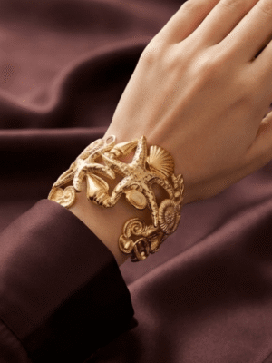 Corail — Gold Starfish Shell Cuff Bracelet worn on wrist Corail — Gold Starfish Shell Cuff Bracelet worn on wrist