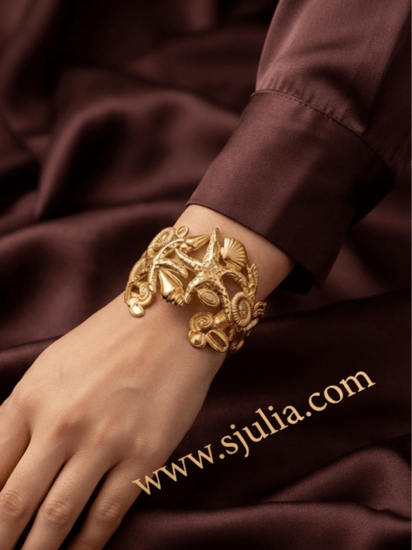 Corail — Gold Starfish Shell Cuff Bracelet worn on wrist Corail — Gold Starfish Shell Cuff Bracelet worn on wrist