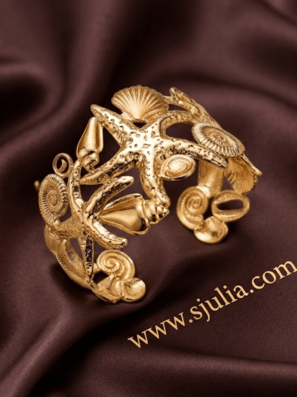 Corail — Gold Starfish Shell Cuff Bracelet worn on wrist Corail — Gold Starfish Shell Cuff Bracelet worn on wrist