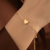 Dil — Gold Heart Charm Bracelet worn on wrist Dil — Gold Heart Charm Bracelet worn on wrist