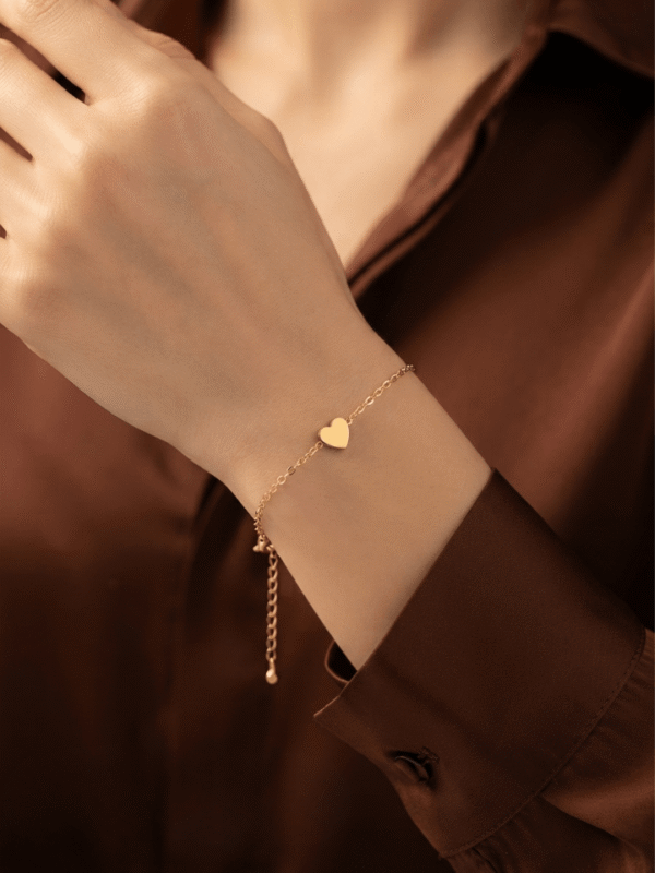 Dil — Gold Heart Charm Bracelet worn on wrist Dil — Gold Heart Charm Bracelet worn on wrist