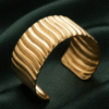 Vela — Gold Ribbed Cuff Bracelet worn on wrist Vela — Gold Ribbed Cuff Bracelet worn on wrist