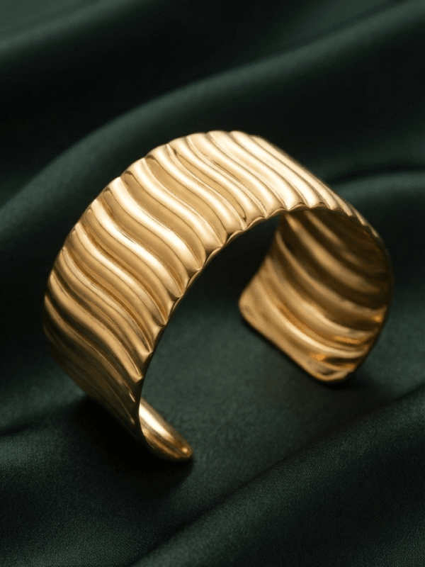 Vela — Gold Ribbed Cuff Bracelet worn on wrist Vela — Gold Ribbed Cuff Bracelet worn on wrist