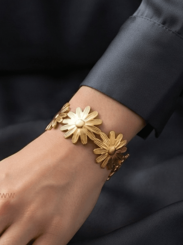 Marguerite — Gold Daisy Flower Bracelet worn on wrist Marguerite — Gold Daisy Flower Bracelet worn on wrist