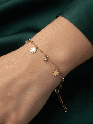 Marguerite — Gold Daisy Charm Bracelet worn on wrist Marguerite — Gold Daisy Charm Bracelet worn on wrist