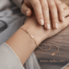 Infini — Gold Infinity Link Bracelet worn on wrist Infini — Gold Infinity Link Bracelet worn on wrist