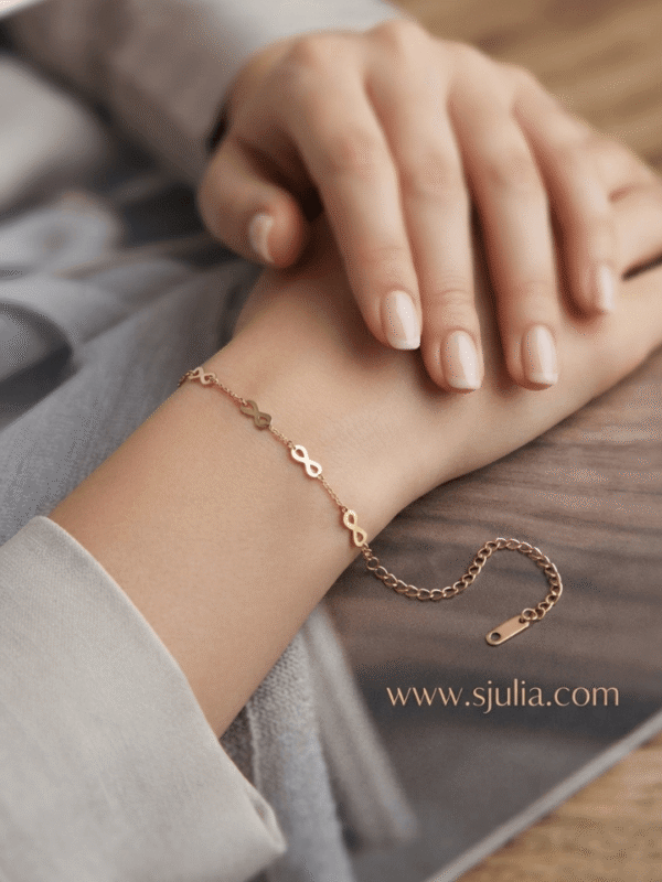 Infini — Gold Infinity Link Bracelet worn on wrist Infini — Gold Infinity Link Bracelet worn on wrist