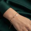 Marguerite — Gold Daisy Charm Bracelet worn on wrist Marguerite — Gold Daisy Charm Bracelet worn on wrist