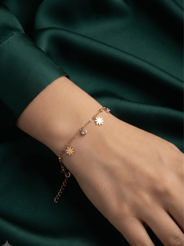 Marguerite — Gold Daisy Charm Bracelet worn on wrist Marguerite — Gold Daisy Charm Bracelet worn on wrist