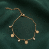Marguerite — Gold Daisy Charm Bracelet worn on wrist Marguerite — Gold Daisy Charm Bracelet worn on wrist