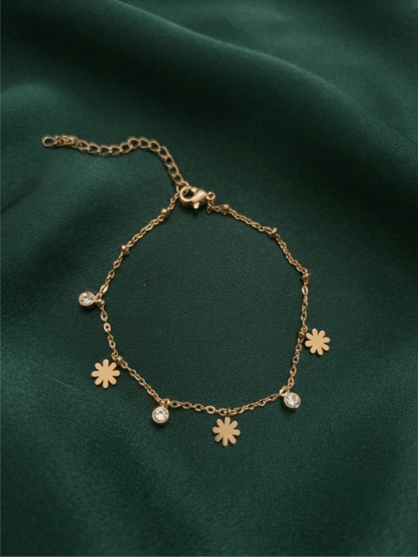 Marguerite — Gold Daisy Charm Bracelet worn on wrist Marguerite — Gold Daisy Charm Bracelet worn on wrist