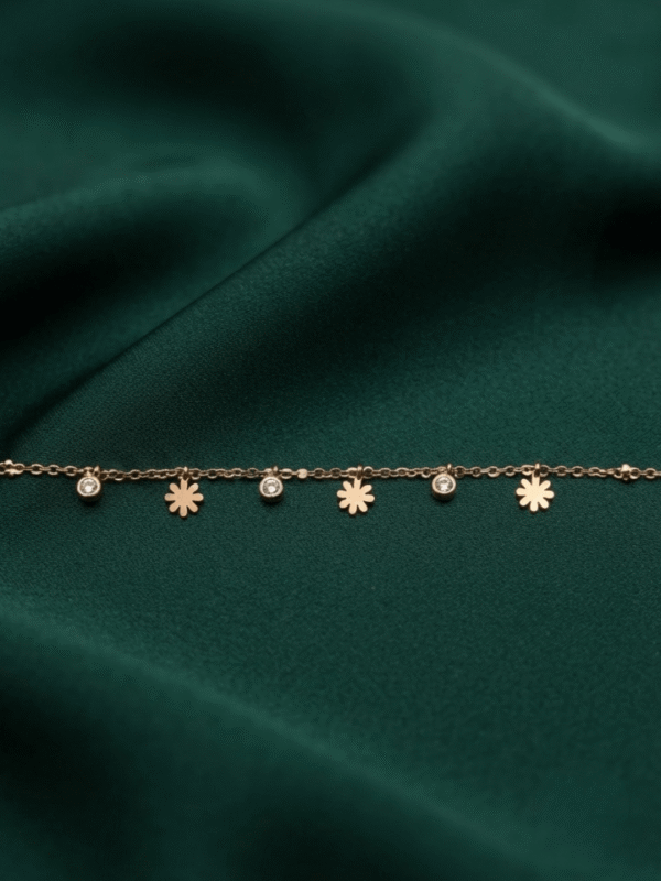 Marguerite — Gold Daisy Charm Bracelet worn on wrist Marguerite — Gold Daisy Charm Bracelet worn on wrist
