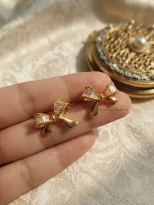 Nira β Gold Baguette Crystal Bow Studs Nira β Gold Baguette Crystal Bow Studs