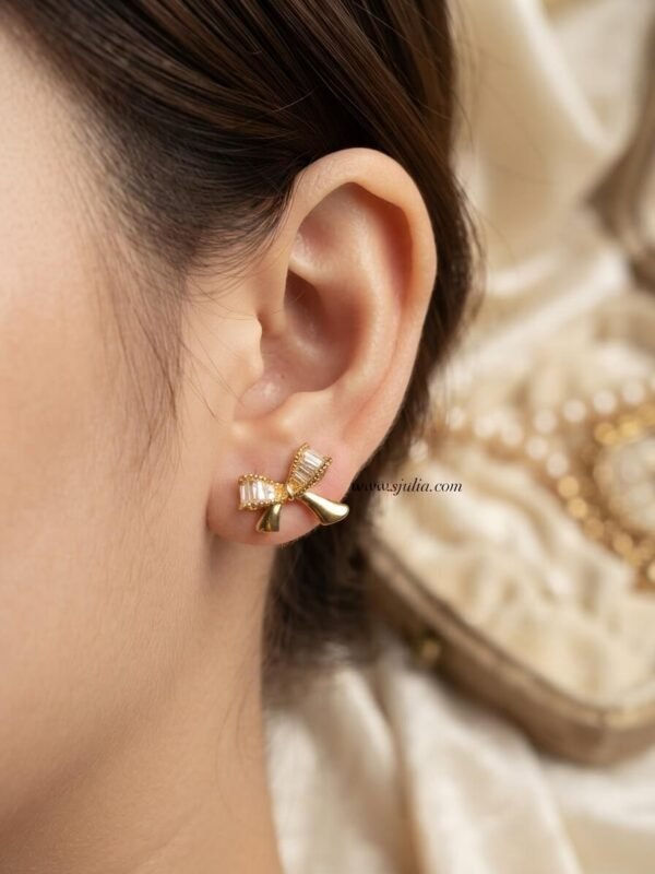 Nira – Gold Baguette Crystal Bow Studs Nira – Gold Baguette Crystal Bow Studs