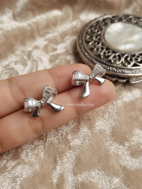 Nira – Gold Baguette Crystal Bow Studs Nira – Gold Baguette Crystal Bow Studs